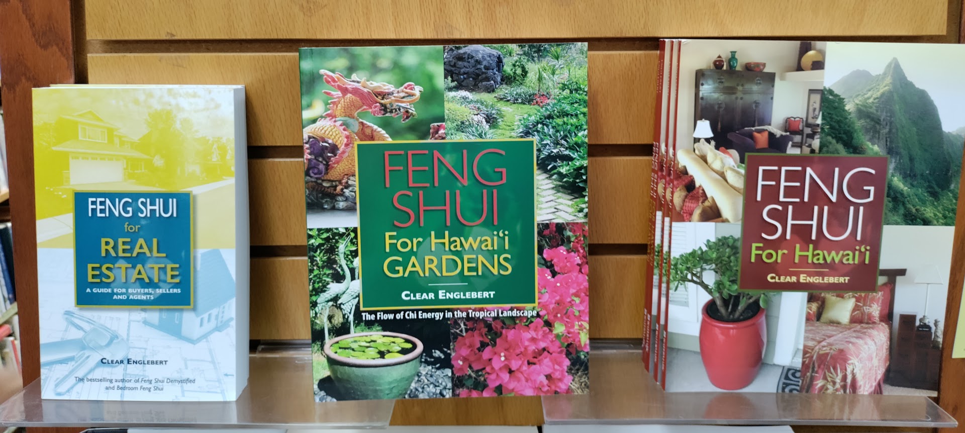 Clear Englebert's books Feng Shui for Real Estate, Feng Shui for Hawaii Gardens and Feng Shui for Hawaii on display on a bookshelf.